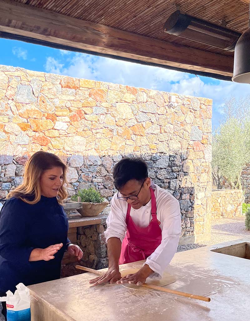 Chef Argiro with contestant Sam. Guiding him how to open phyllo pastry.